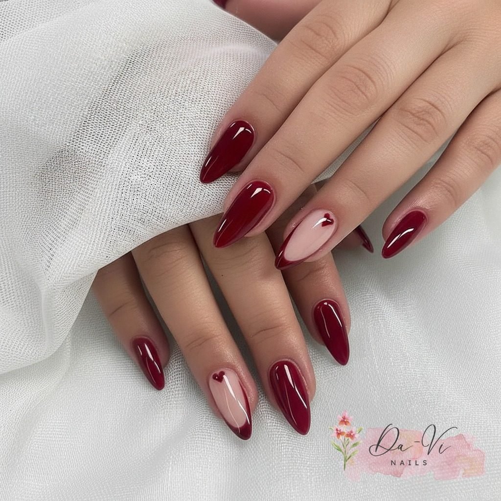 glossy deep red almond shaped manicure with white and red heart accent nail