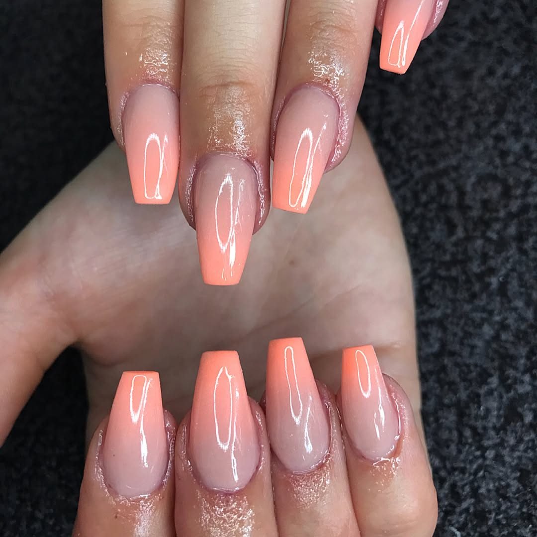 coffin shaped nails with a soft peach to nude ombre gradient manicure design