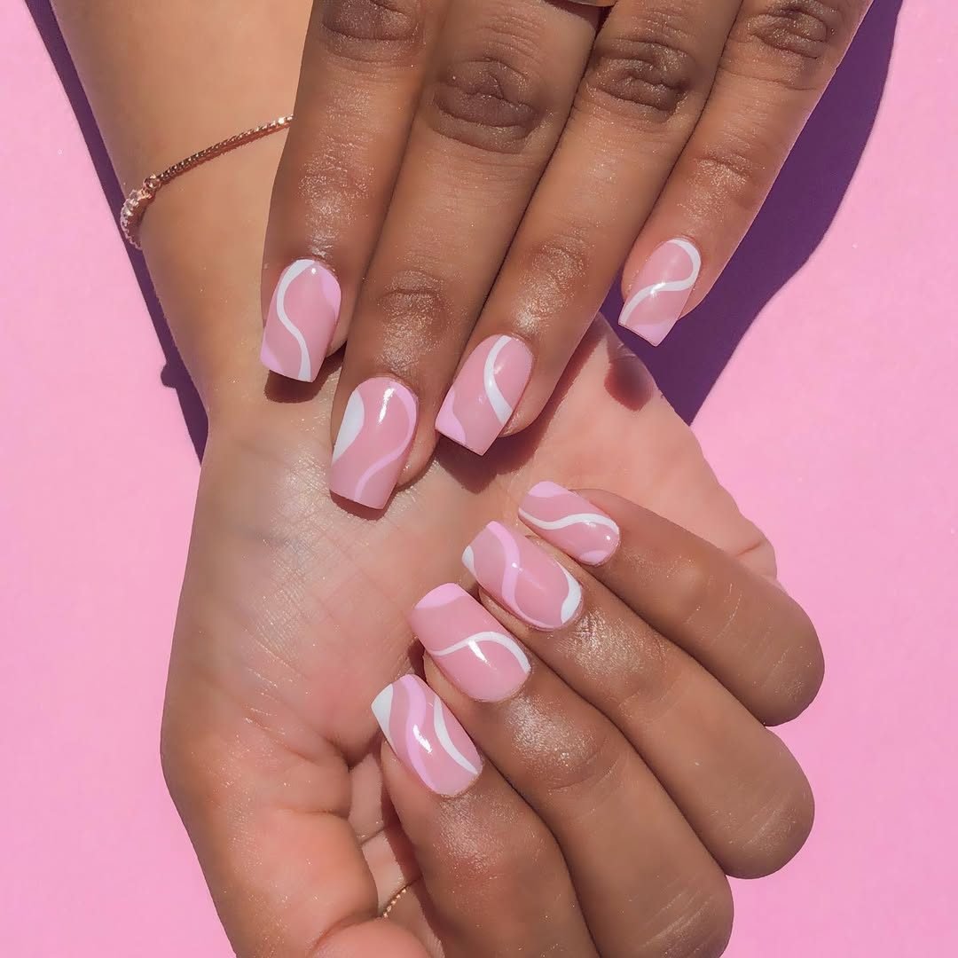 pink square press on nails with white abstract wavy lines on a pink background