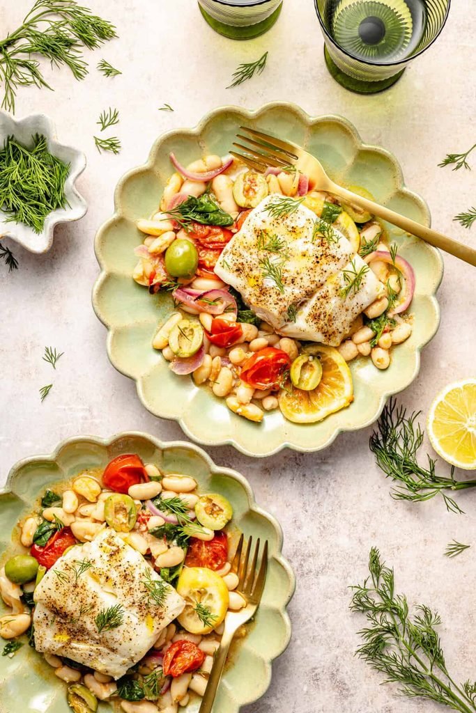 baked cod fillets served over garlicky white beans, tomatoes, olives, and fresh dill
