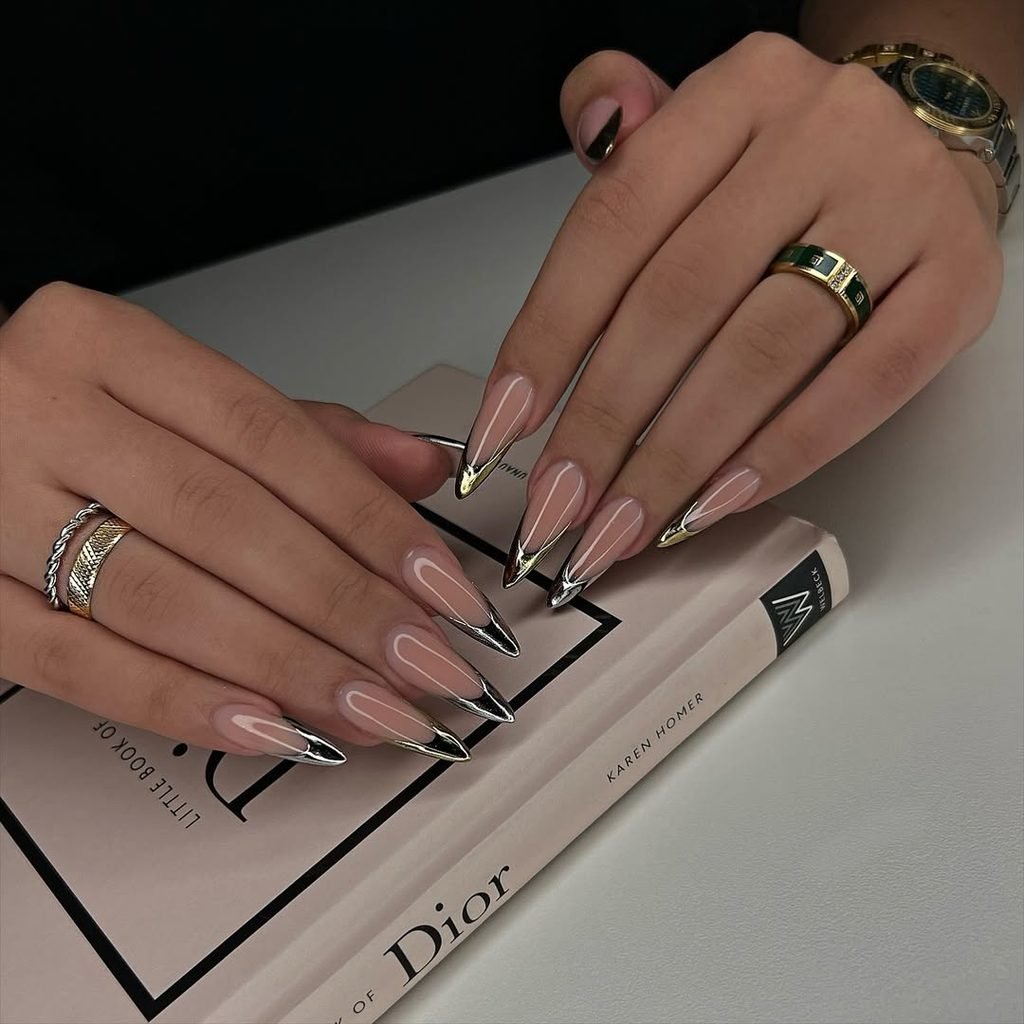 long pointed nails with nude bases and shiny metallic silver french tips