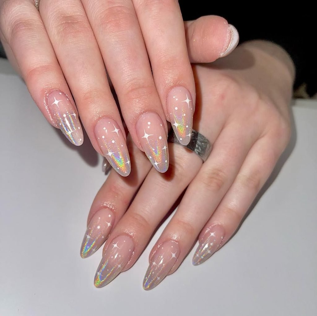 long almond nails with holographic glitter gradients and white starburst details