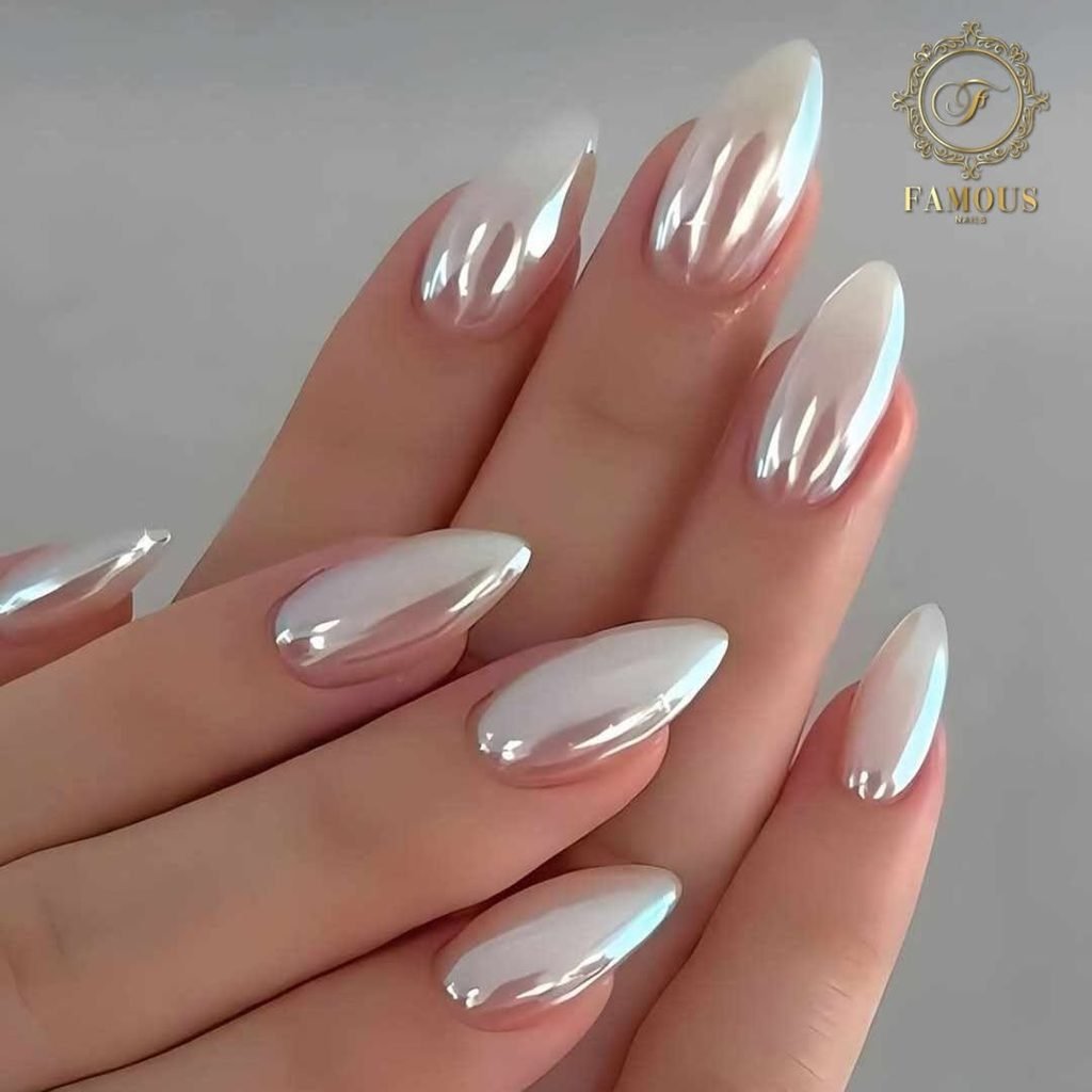long pointed almond nails with a reflective white pearl chrome finish