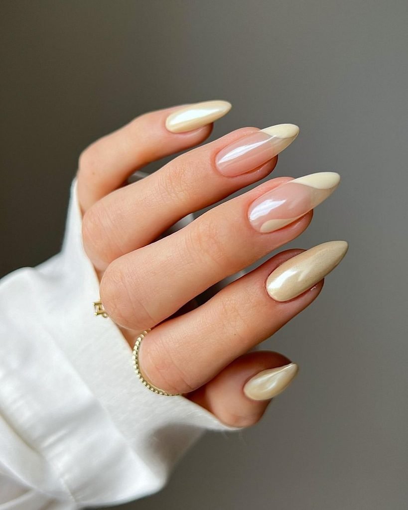 shimmering champagne chrome gel nails with elegant nude wavy french tips