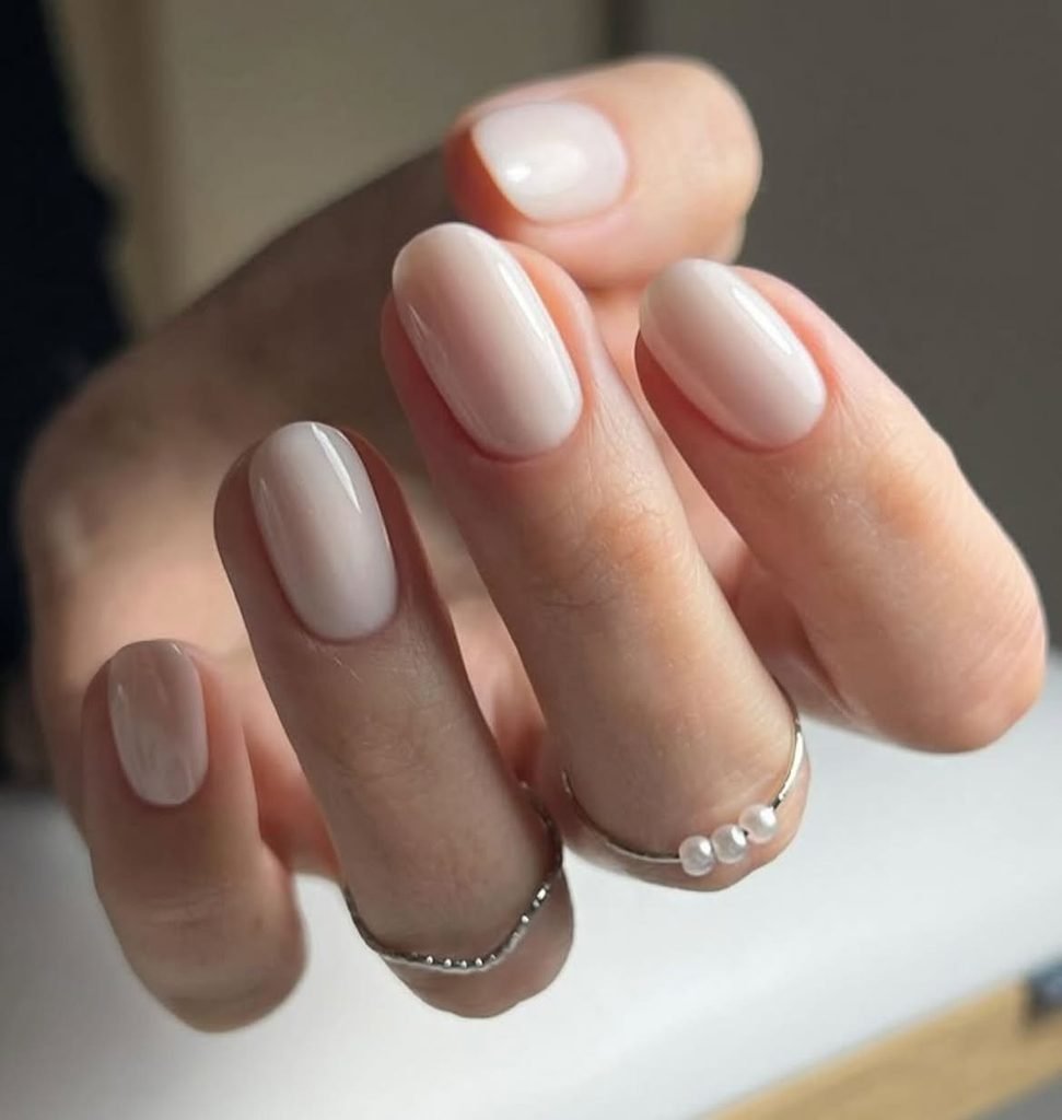 milky white short oval gel nails with a clean glossy minimalist finish