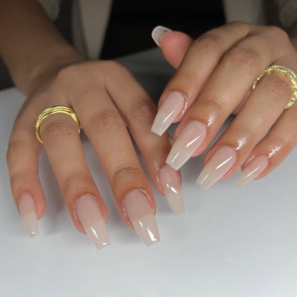 long coffin shaped gel nails in a semi sheer milky nude ombre finish