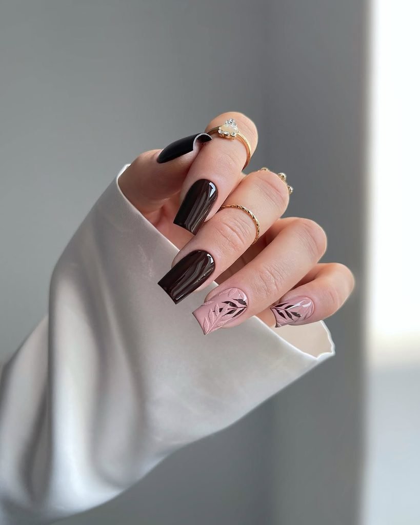 glossy dark brown gel nails paired with matte pink leaf accent art