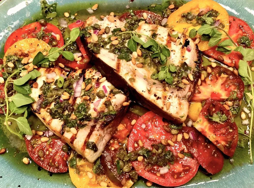 grilled swordfish fillets with heirloom tomatoes, capers, pine nuts, and fresh herbs