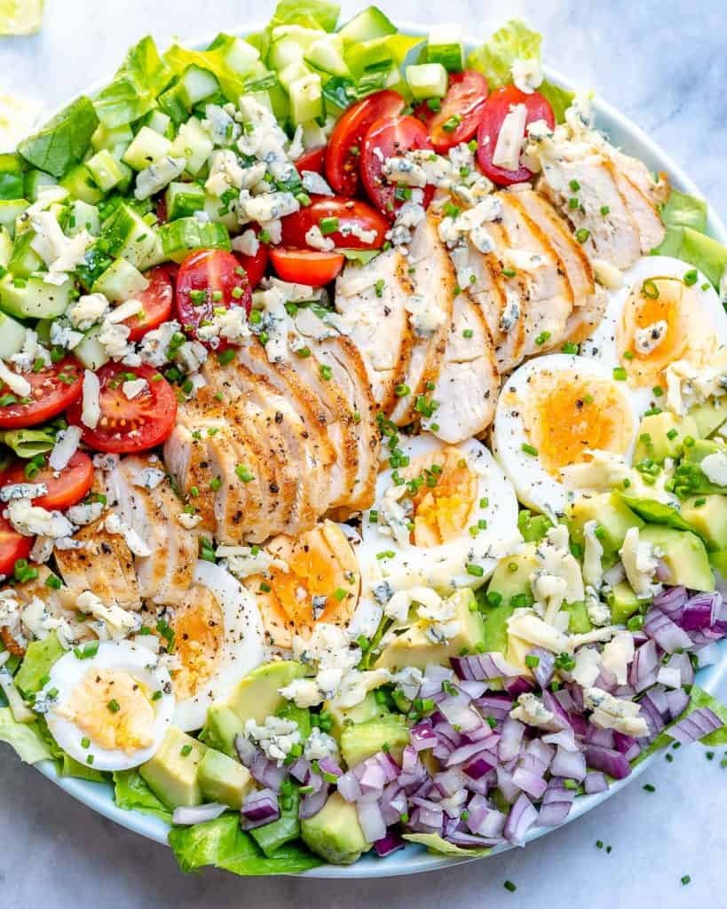 grilled chicken cobb salad with hard boiled eggs avocado tomatoes blue cheese and red onion