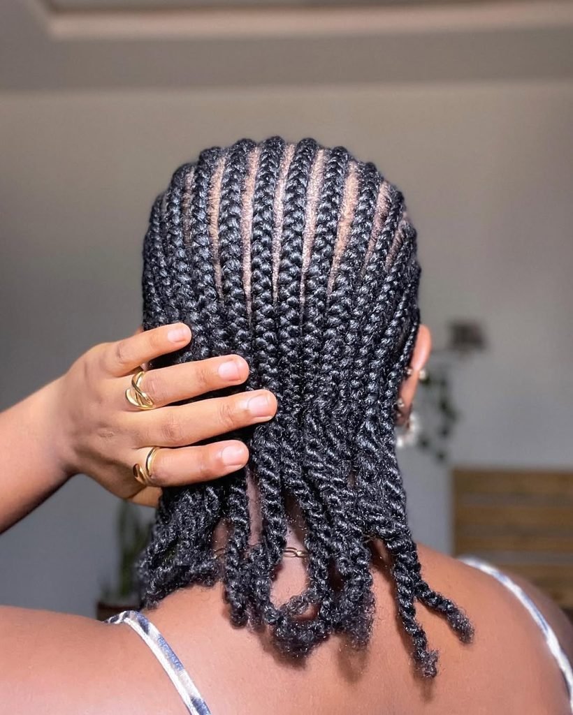 back view of neat straight-back cornrow braids on dark hair
