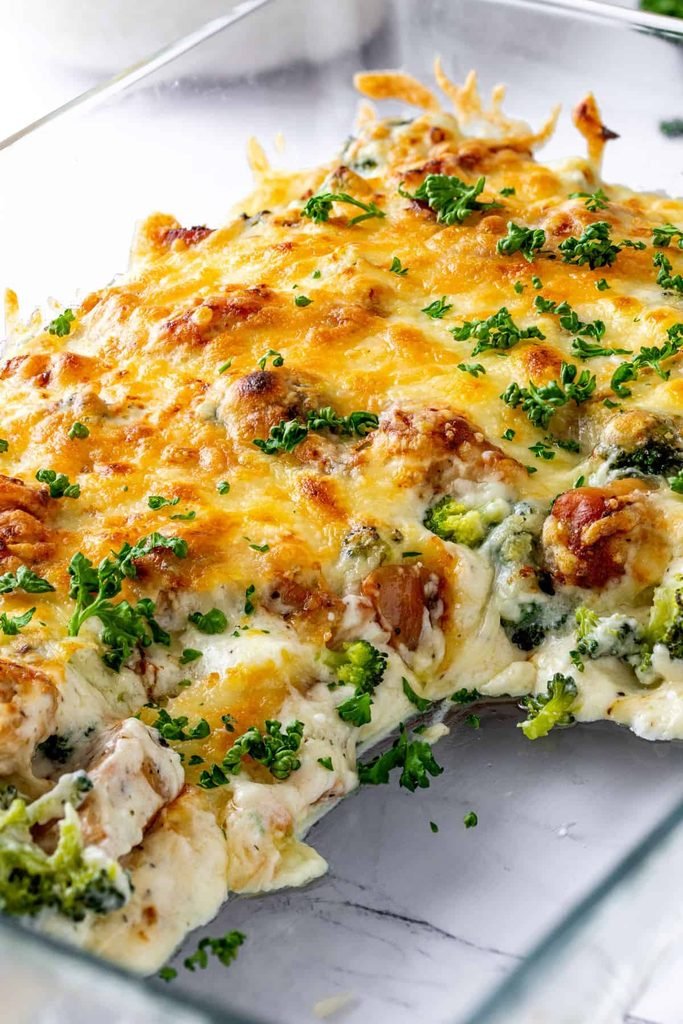keto chicken alfredo casserole bake with broccoli and melted cheese in a baking dish