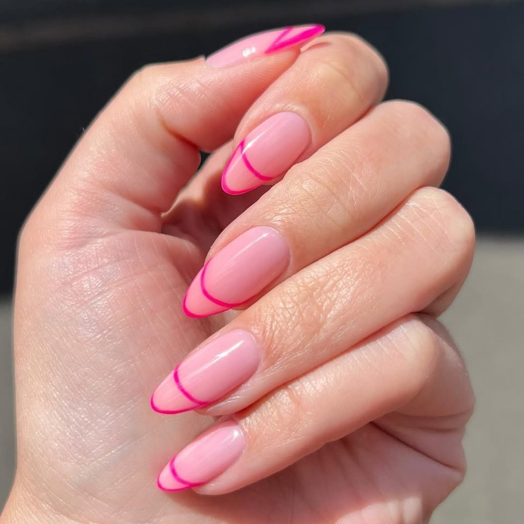 long almond nails with light pink base and hot pink outline french tips