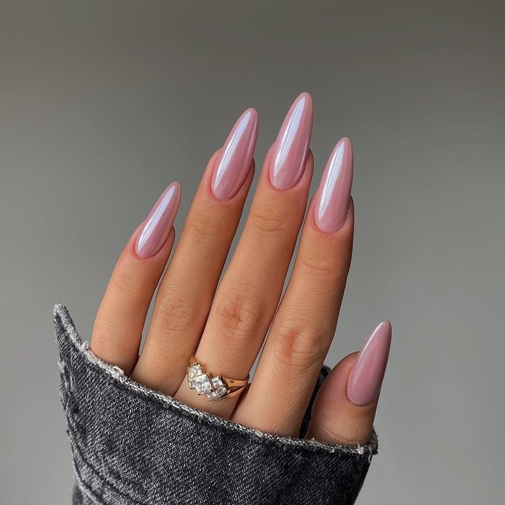 long almond nails with a metallic lavender pink chrome finish and ring