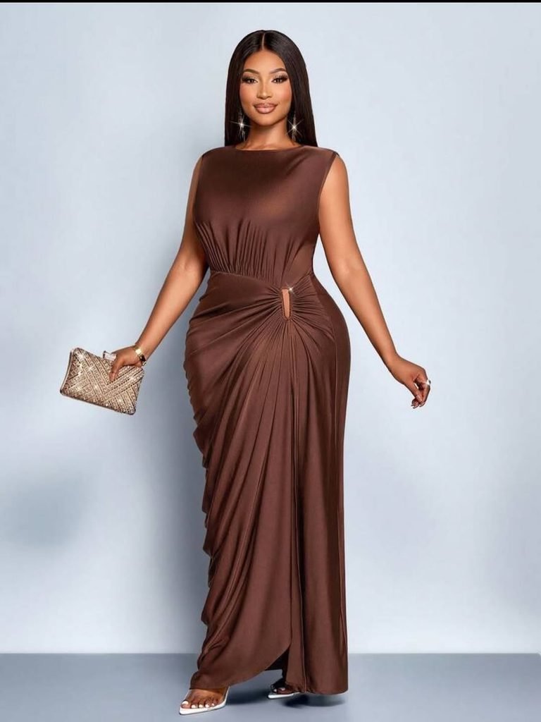 woman wearing a sleeveless floor-length brown gown with side ruching and gold clutch