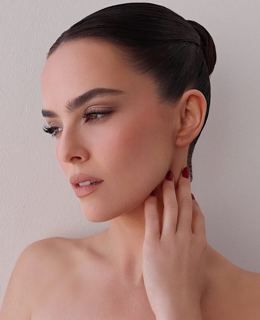 woman with a slicked back sleek low bun summer hairstyle