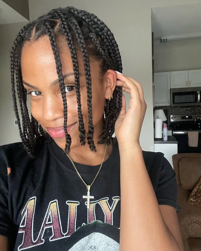 smiling woman wearing a short box braid bob summer hairstyle