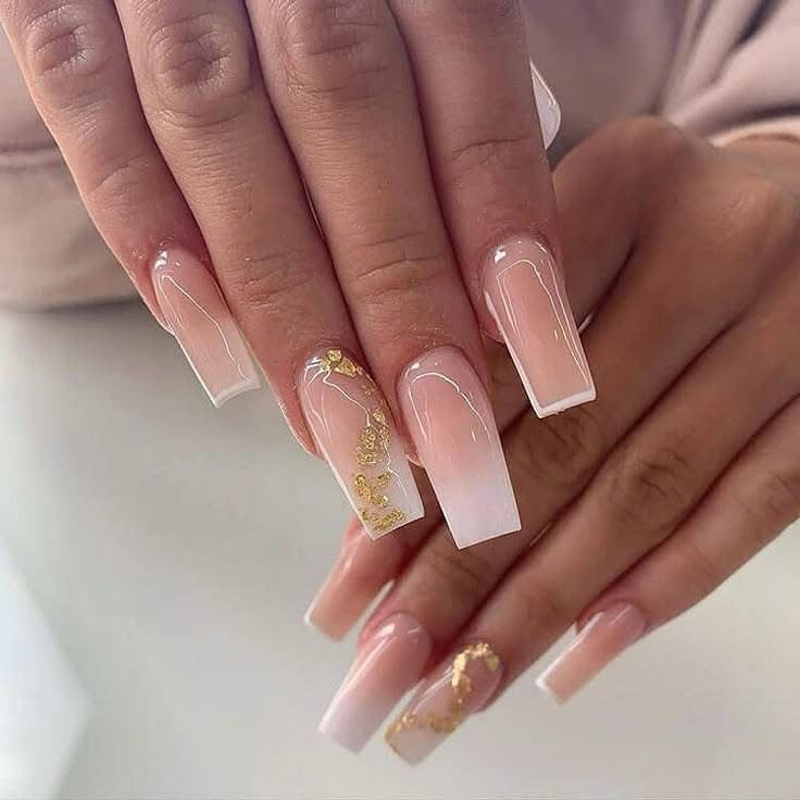 long square ombre nails featuring a nude base white tips and gold foil accents