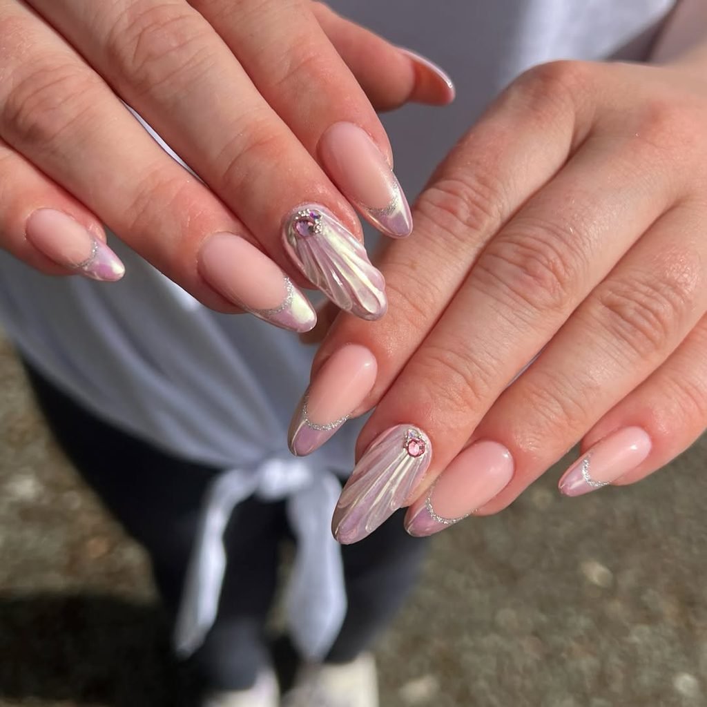 shimmering pink mermaid chrome nails with iridescent raised seashell texture details