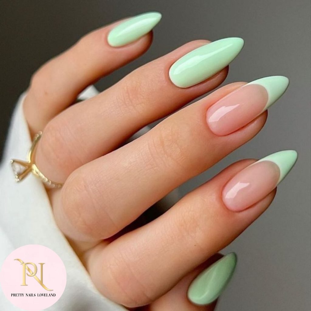 long almond nails with mint green polish and classic french tip accents