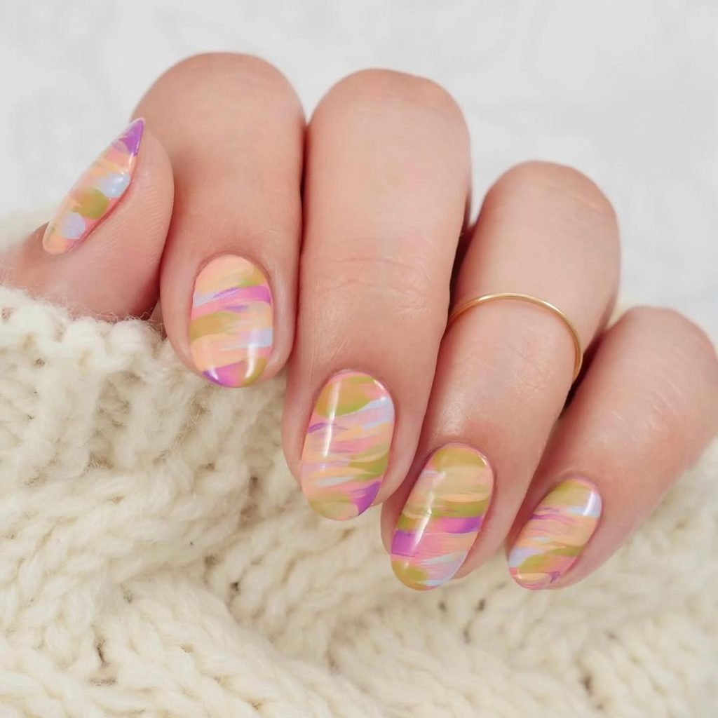 abstract colorful brush stroke nail art in pastel pink orange green and purple shades