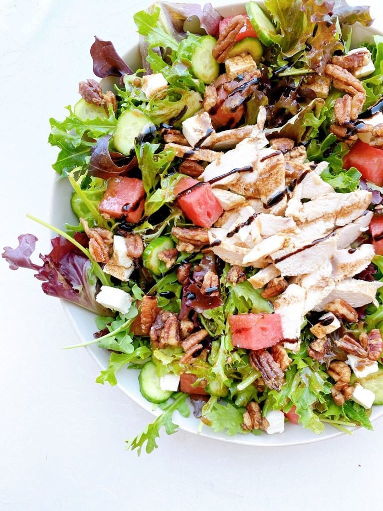 chicken and watermelon salad with feta cheese, pecans, and balsamic glaze drizzle