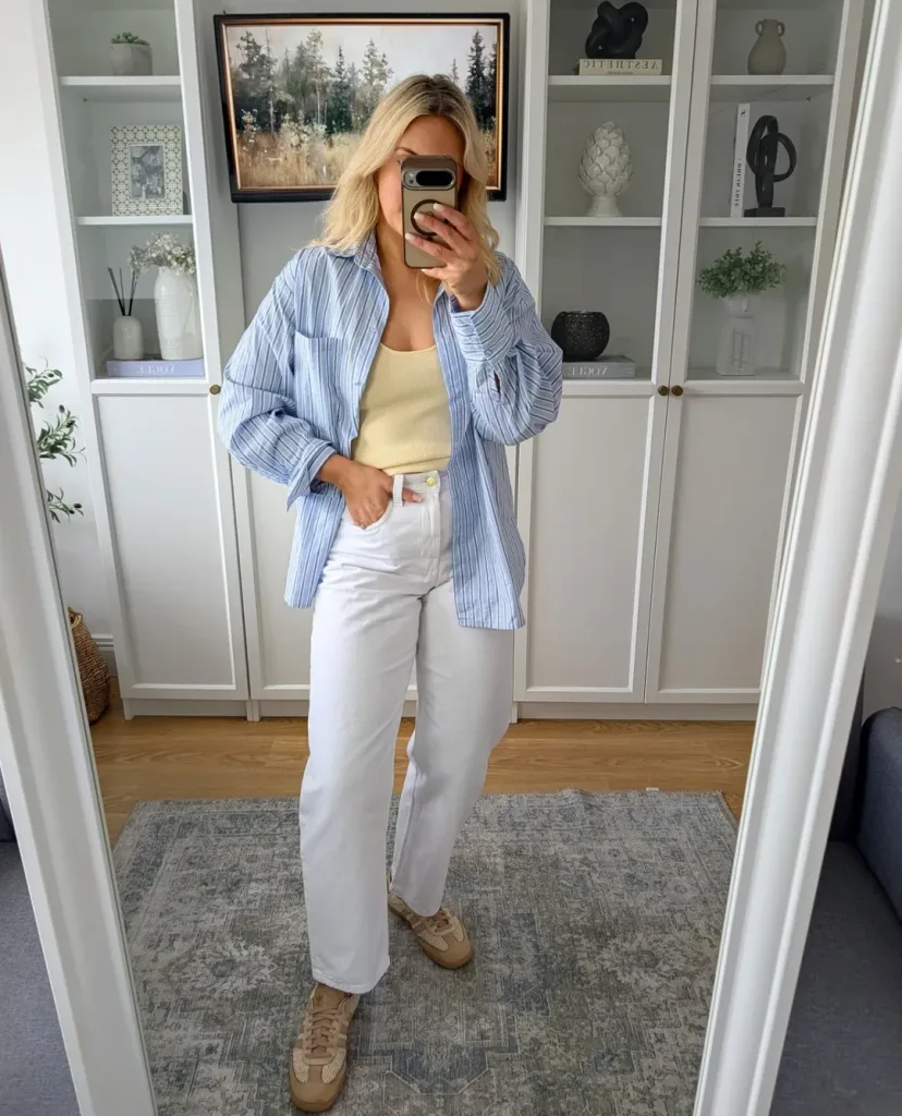 woman in a striped blue button down shirt and white jeans