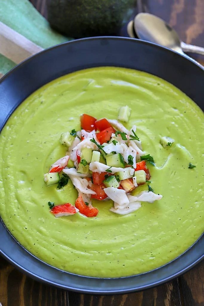 creamy green avocado soup topped with fresh crab meat, cucumber, and diced tomatoes