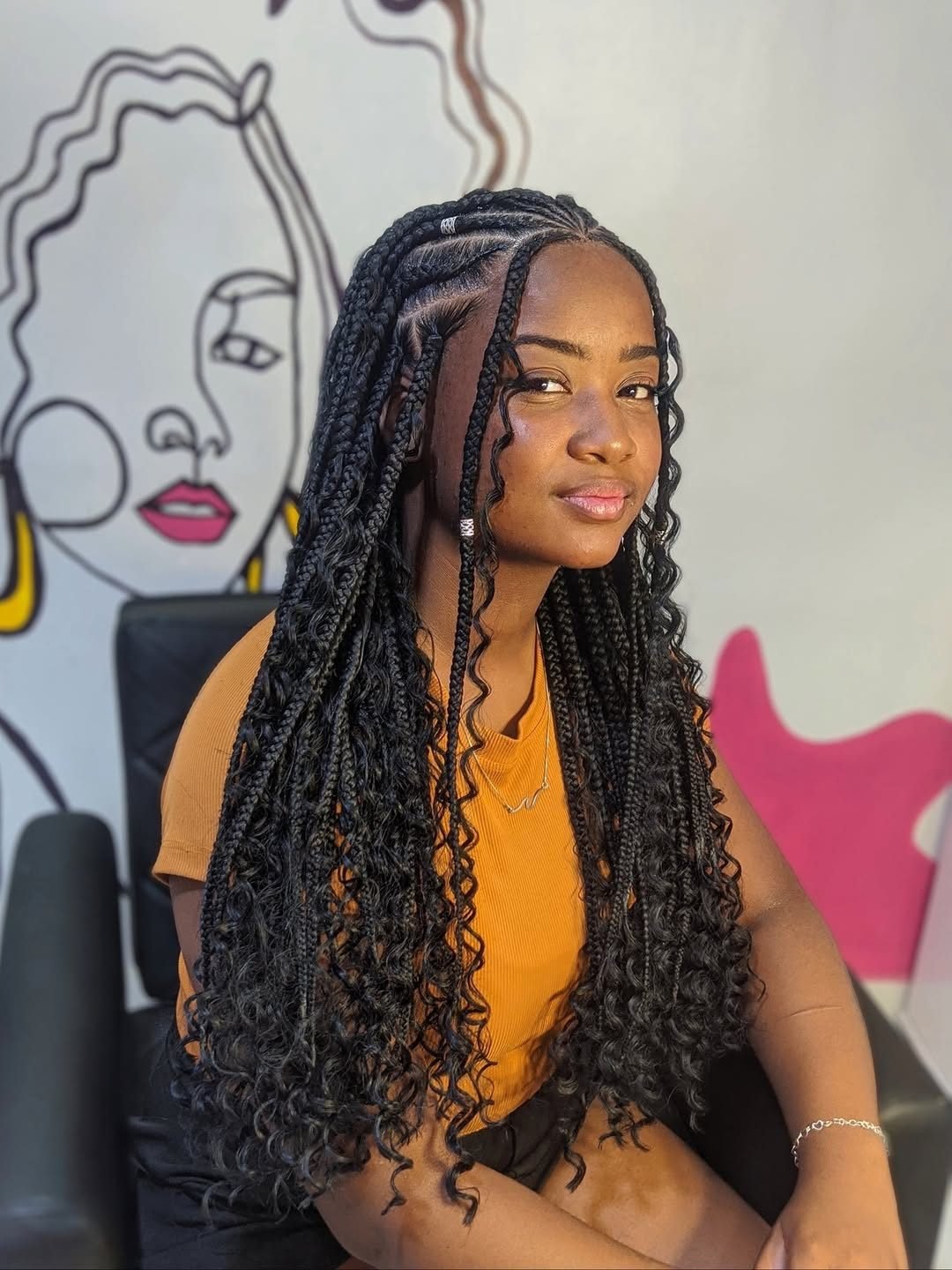 long black fulani braids hairstyle with curly hair extensions, side cornrows, and silver beads