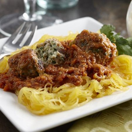 turkey meatballs with marinara sauce served over a bed of spaghetti squash