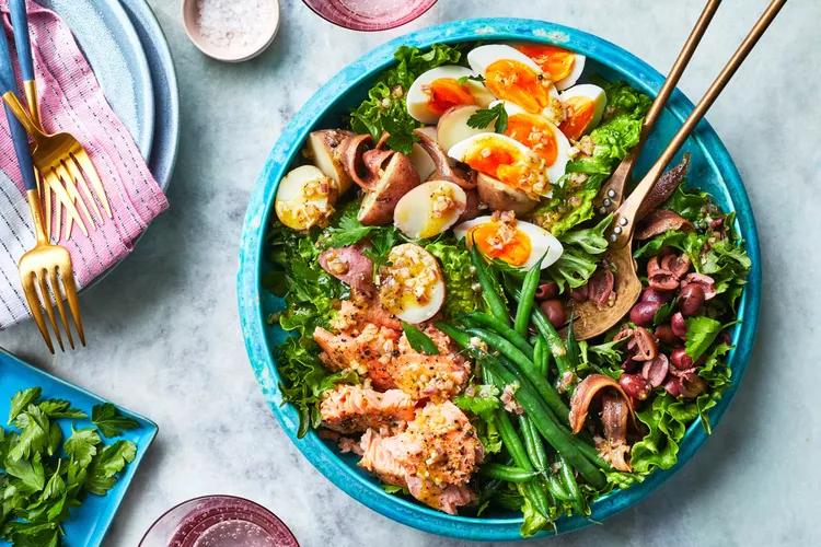 colorful salmon nicoise salad with hard-boiled eggs, green beans, and potatoes