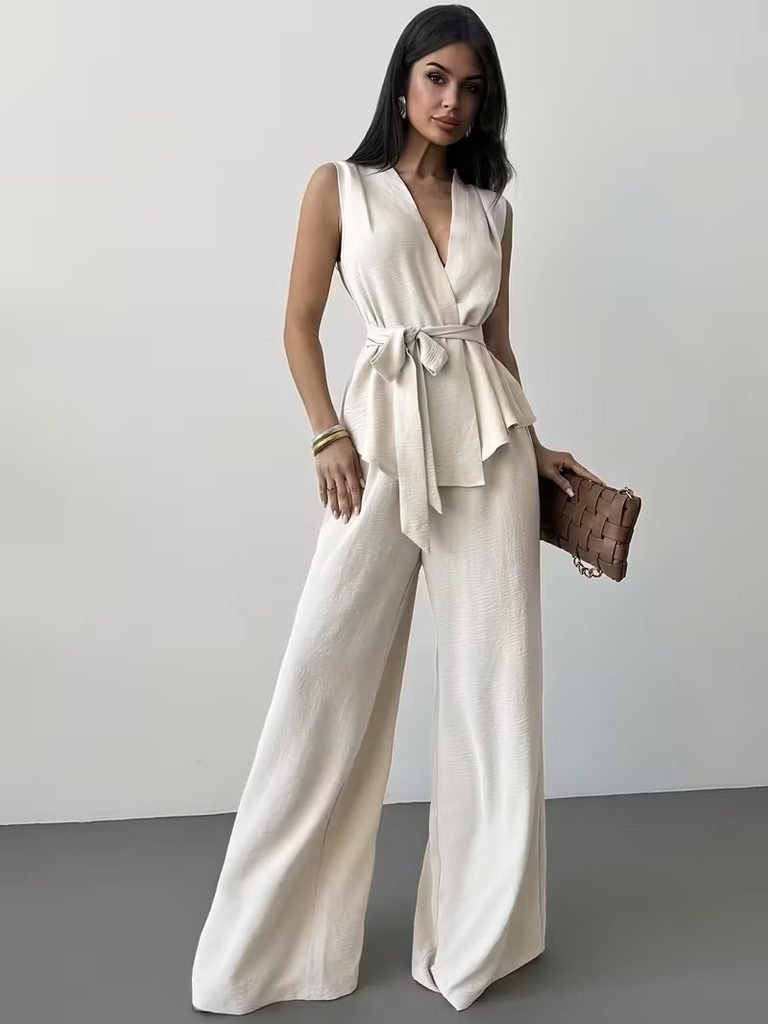 woman wearing cream sleeveless wrap top and matching wide leg pants