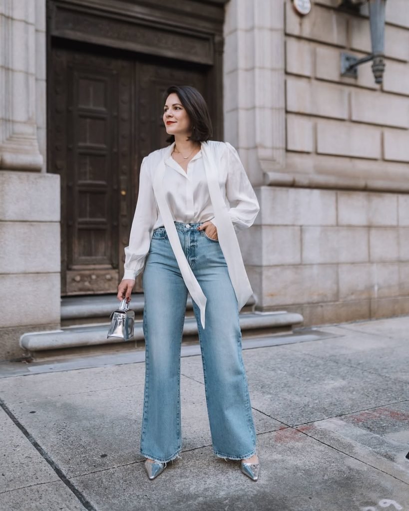 woman wearing white tie front blouse and light wash wide leg jeans