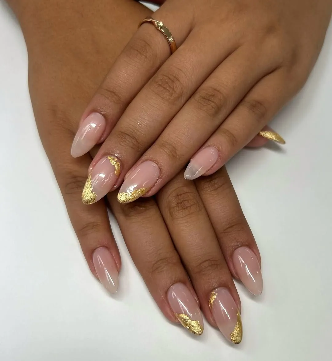 neutral nude almond shaped manicure accented with elegant metallic gold foil details