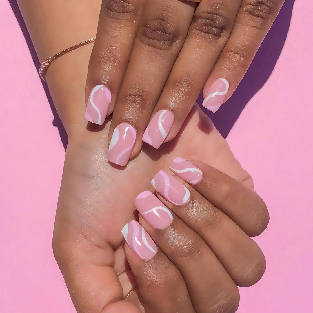 pink square press on nails with white abstract wavy lines on a pink background