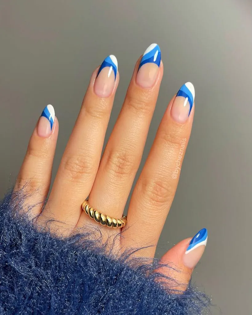 almond nails with multi tonal blue and white wavy abstract french tips
