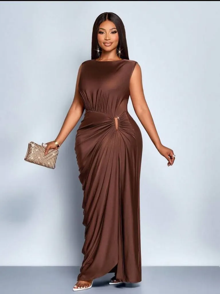 woman wearing a sleeveless floor-length brown gown with side ruching and gold clutch