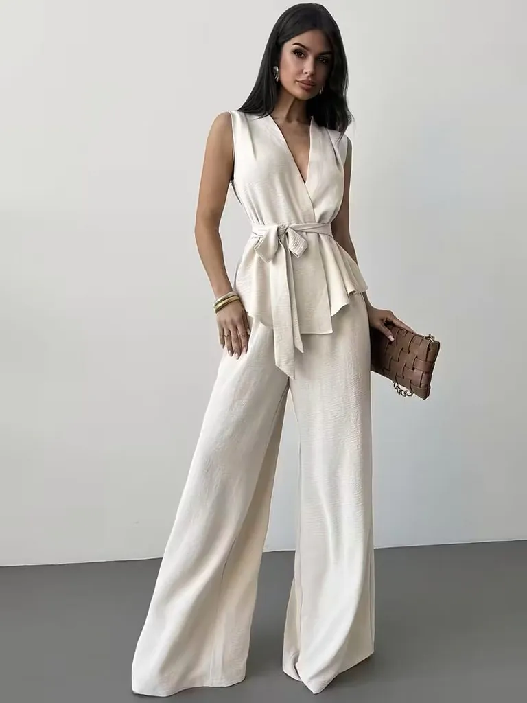 woman wearing cream sleeveless wrap top and matching wide leg pants